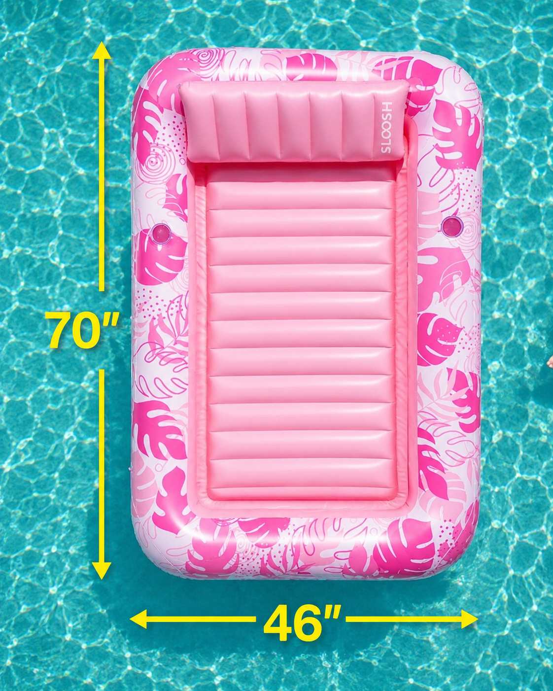 Pink inflatable pool float with floral pattern on a pool