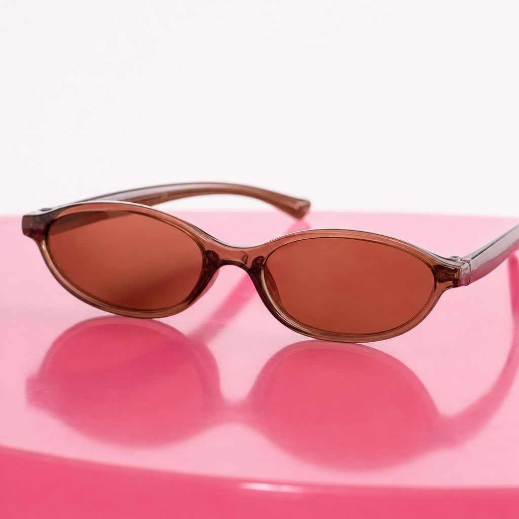 Brown sunglasses on a pink surface